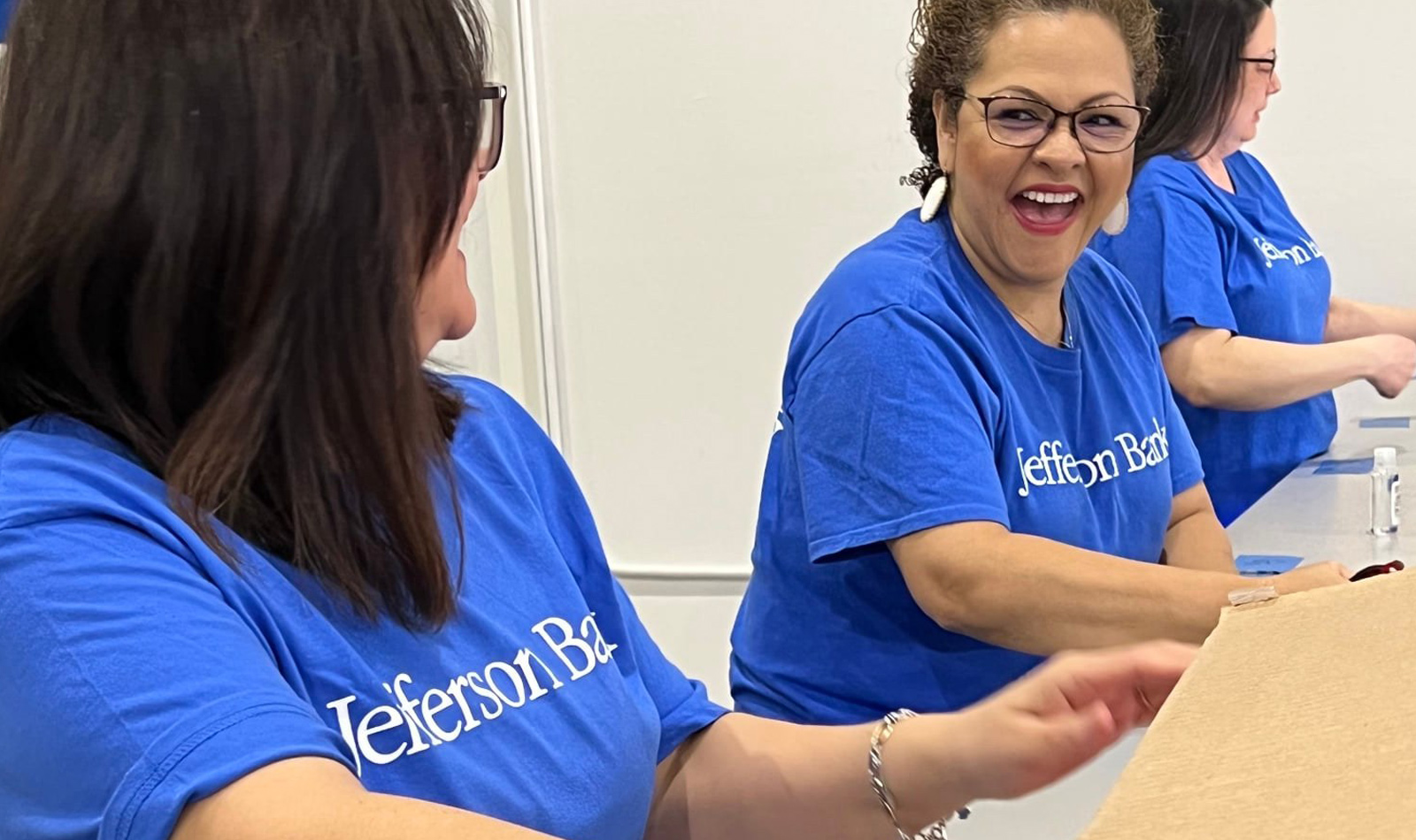 Volunteering at the Texas Diaper Bank re-packaging donated adult  diapers for distribution. pictured left to right: Melissa Johnson (Contact Center),  Lorraine Valera (DTBC), and Debbie Andrew (Compliance)