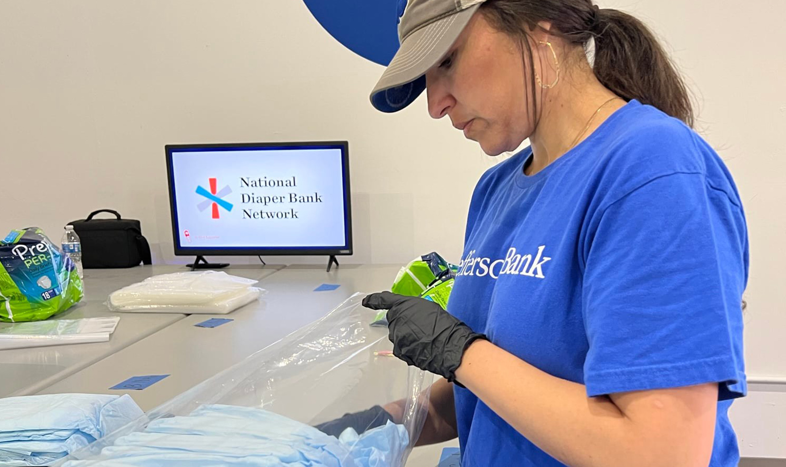 Volunteering at the Texas Diaper Bank Re-packaging donated adult  diapers for distribution. Pictured: Estrellita Garcia-Diaz (CRA)