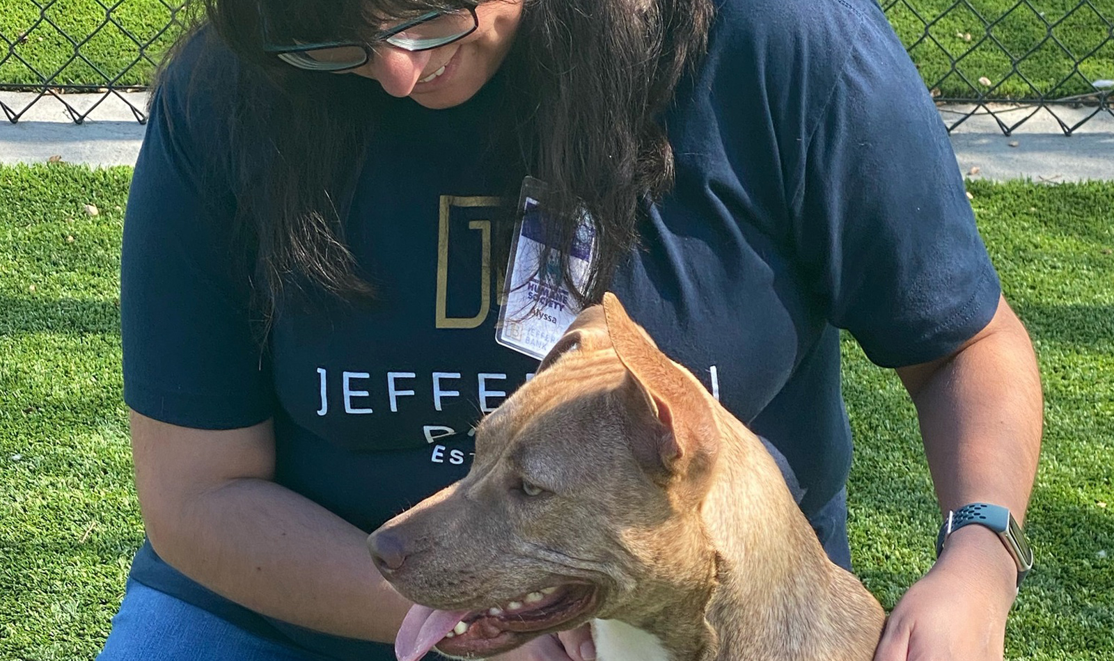 Alyssa Wilcia (Training) trying to get the perfect pose with one of the  Humane Society’s residents during the Pup-arazzi event where volunteers were  tasked with shooting photos and videos of dogs who were ready for adoption.