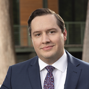 headshot of a man standing outside