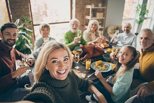 Family taking a selfie around the dinner table