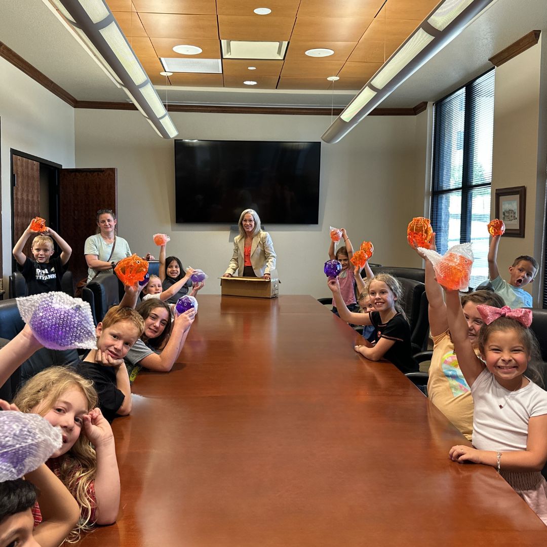 Kids holding crafts during financial literacy event at Jefferson Bank