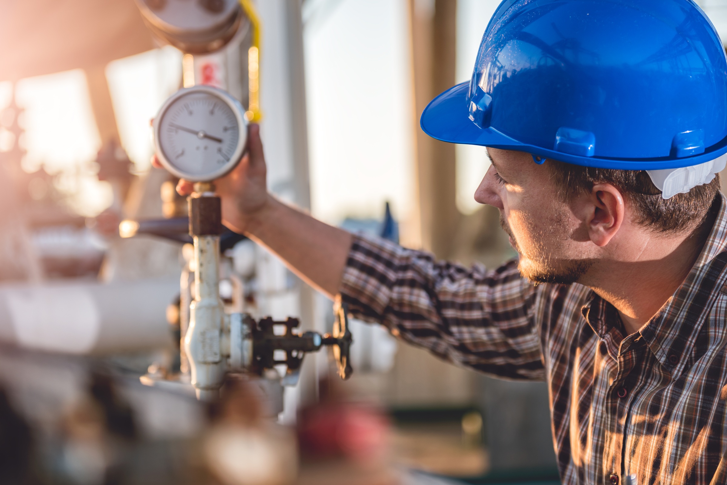 Oil and gas worker inspecting equipment related to mineral rights production and royalties