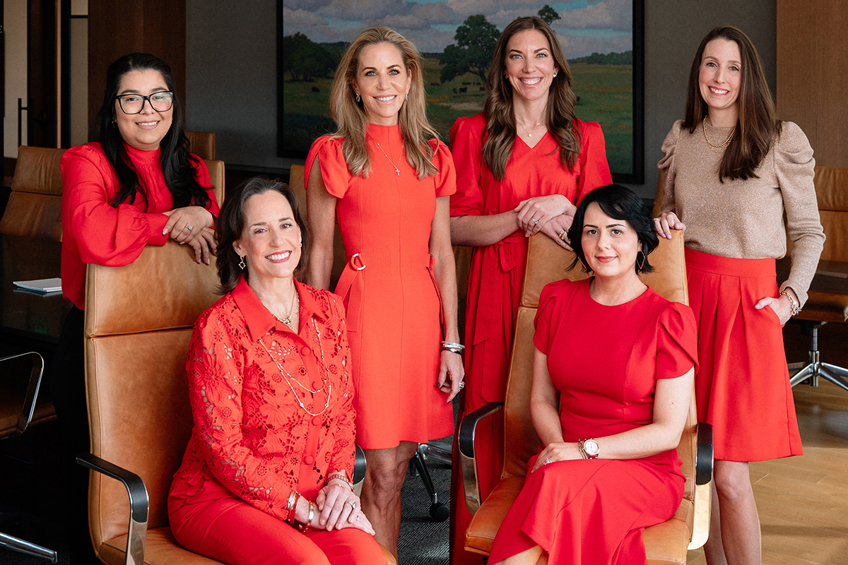 Private banking team members in red in the board room