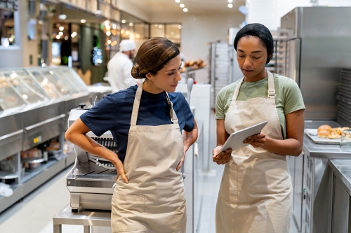 Women in professional kitchen setting