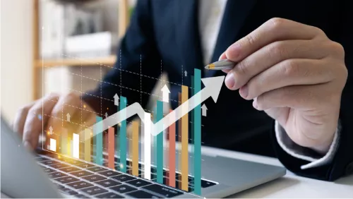 Man on his laptop looking at a graph